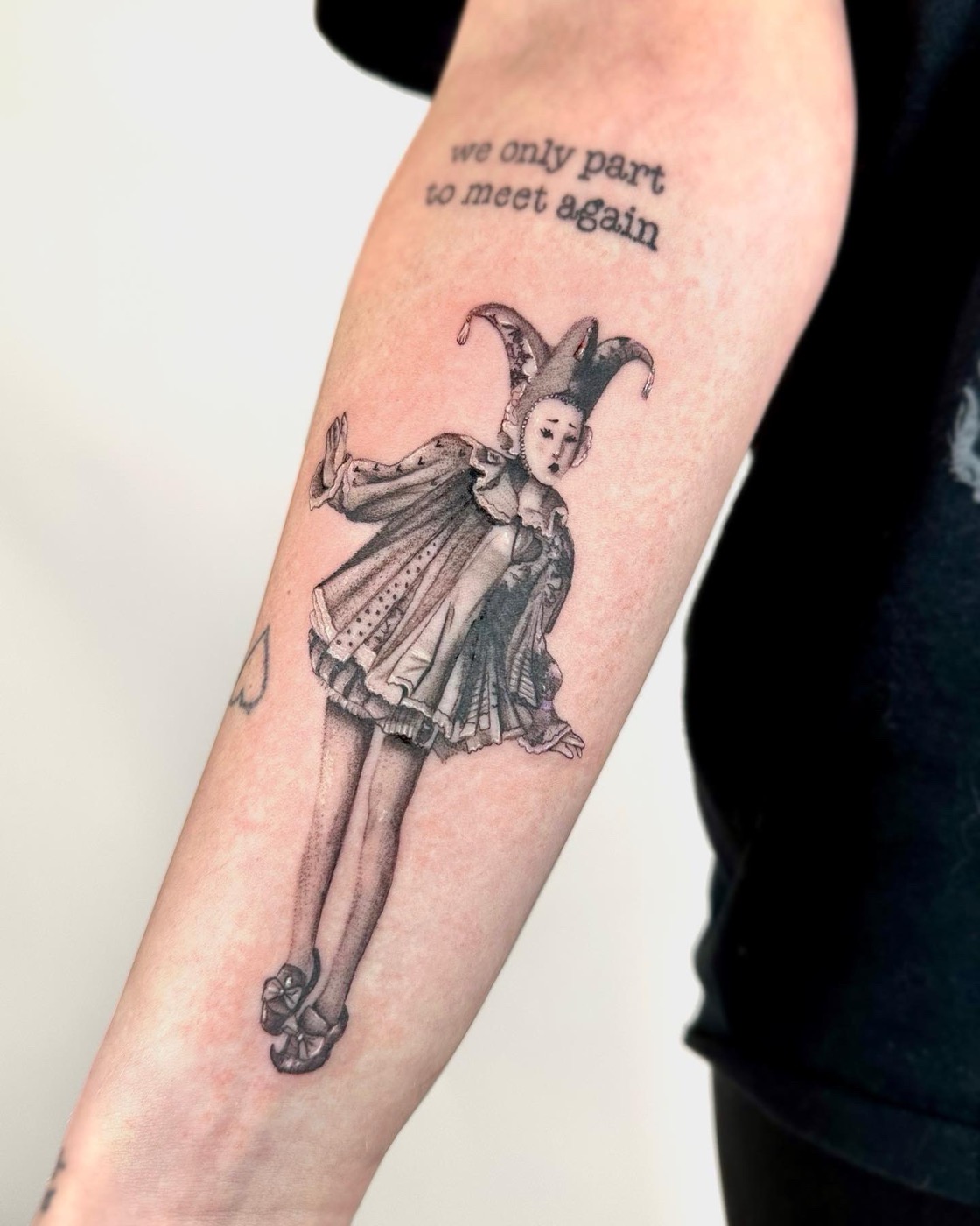 Harlequin/jester with script (arm)